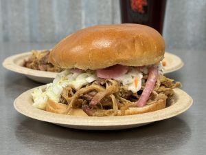 pulled pork sandwich with coleslaw and onions