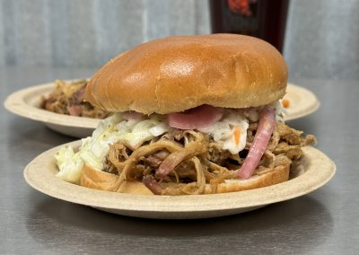 pulled pork sandwich with coleslaw and onions