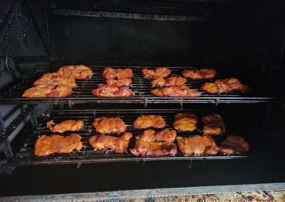 whole chickens being smoked